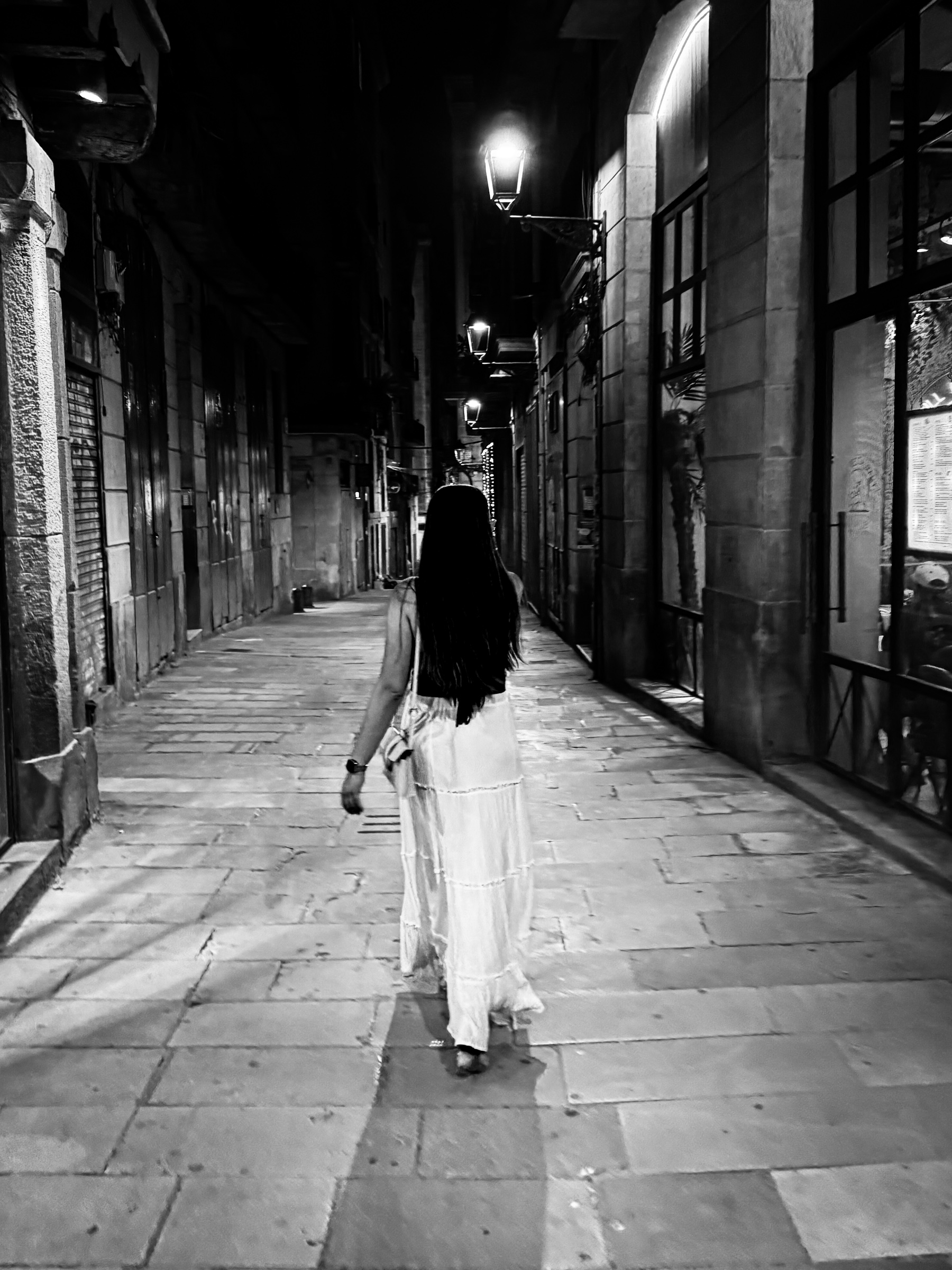 Iyla walking in gothic quarter at night