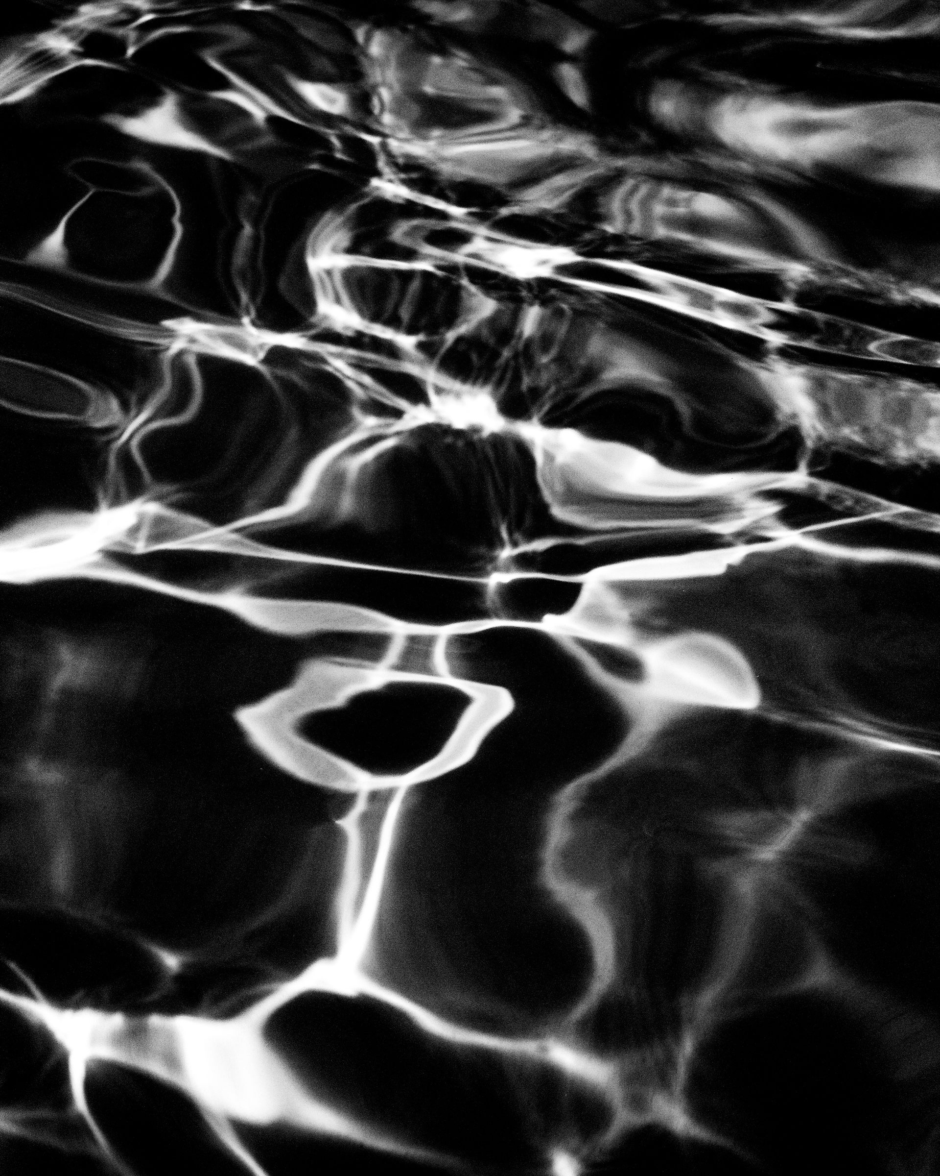 Water surface with reflected light patterns, high contrast — Palm Desert, California