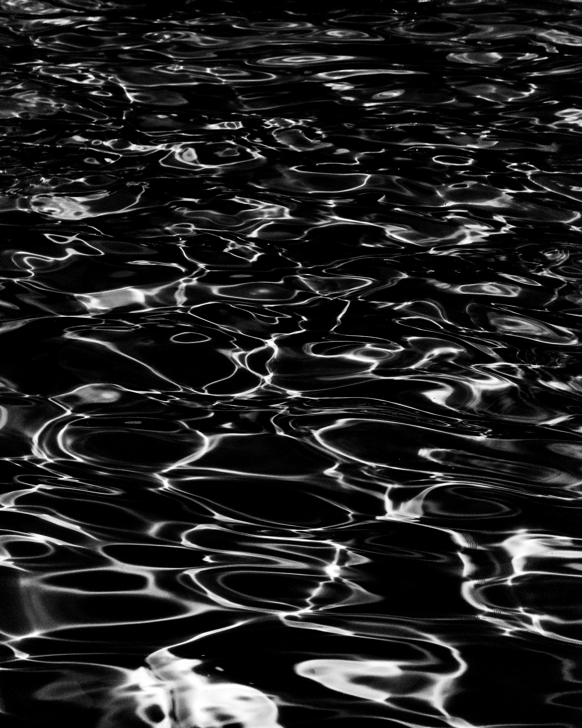 Dark water surface with scattered light reflections — Palm Desert, California