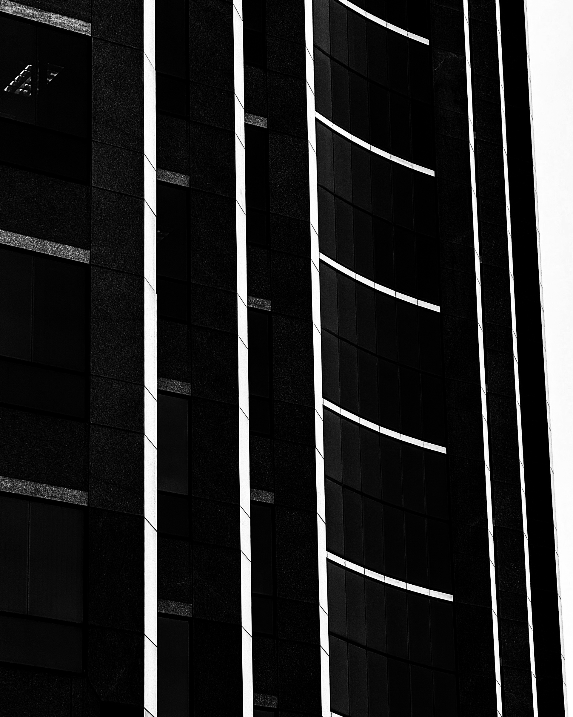 Monochrome abstract image of highrise in Los Angeles with sweeping curved and vertical lines