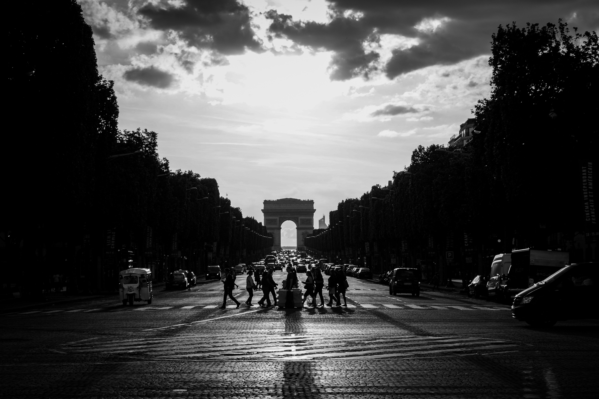 Walking across boulevard with arc