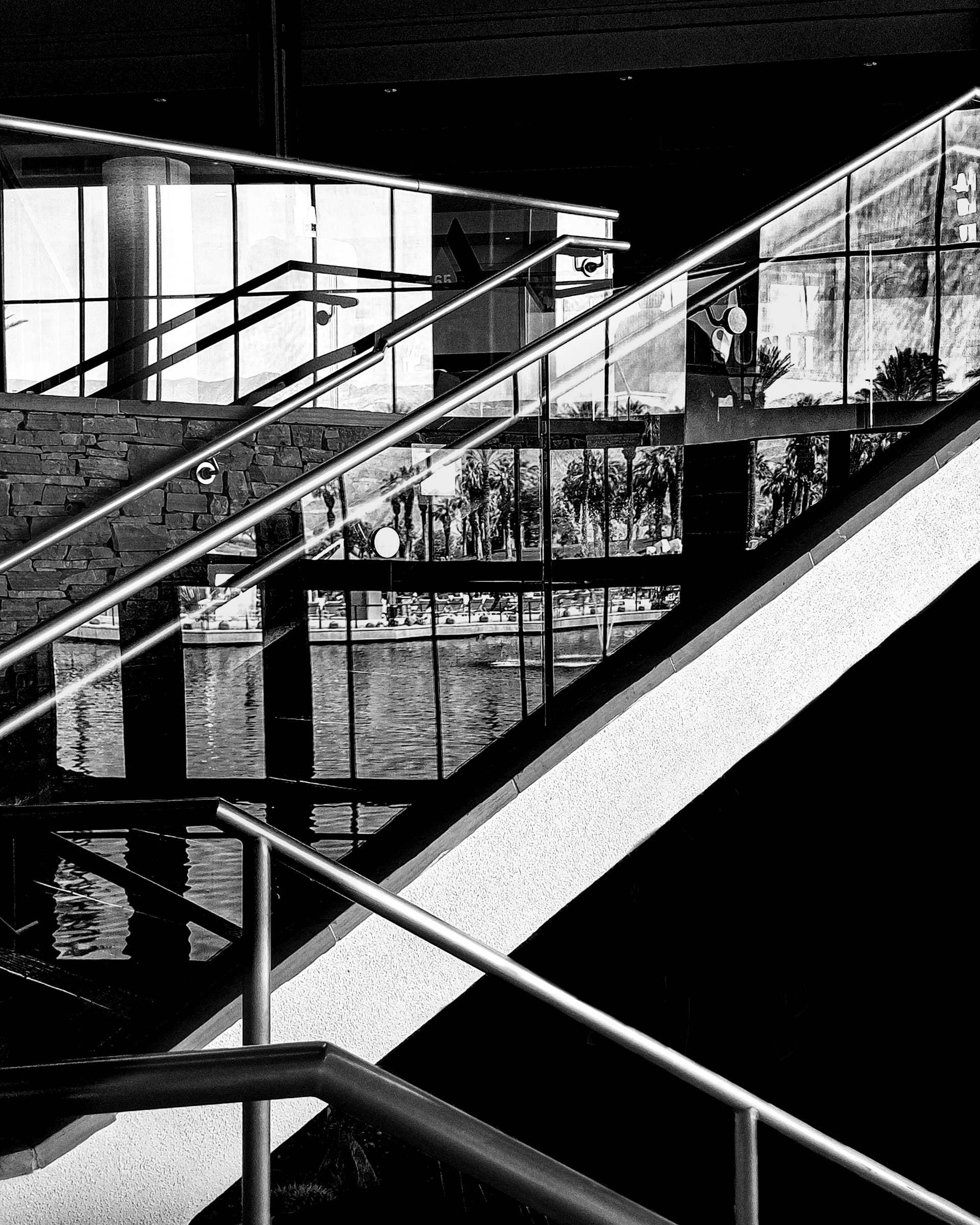 Pond reflecting in glass stairway — Palm Desert, California