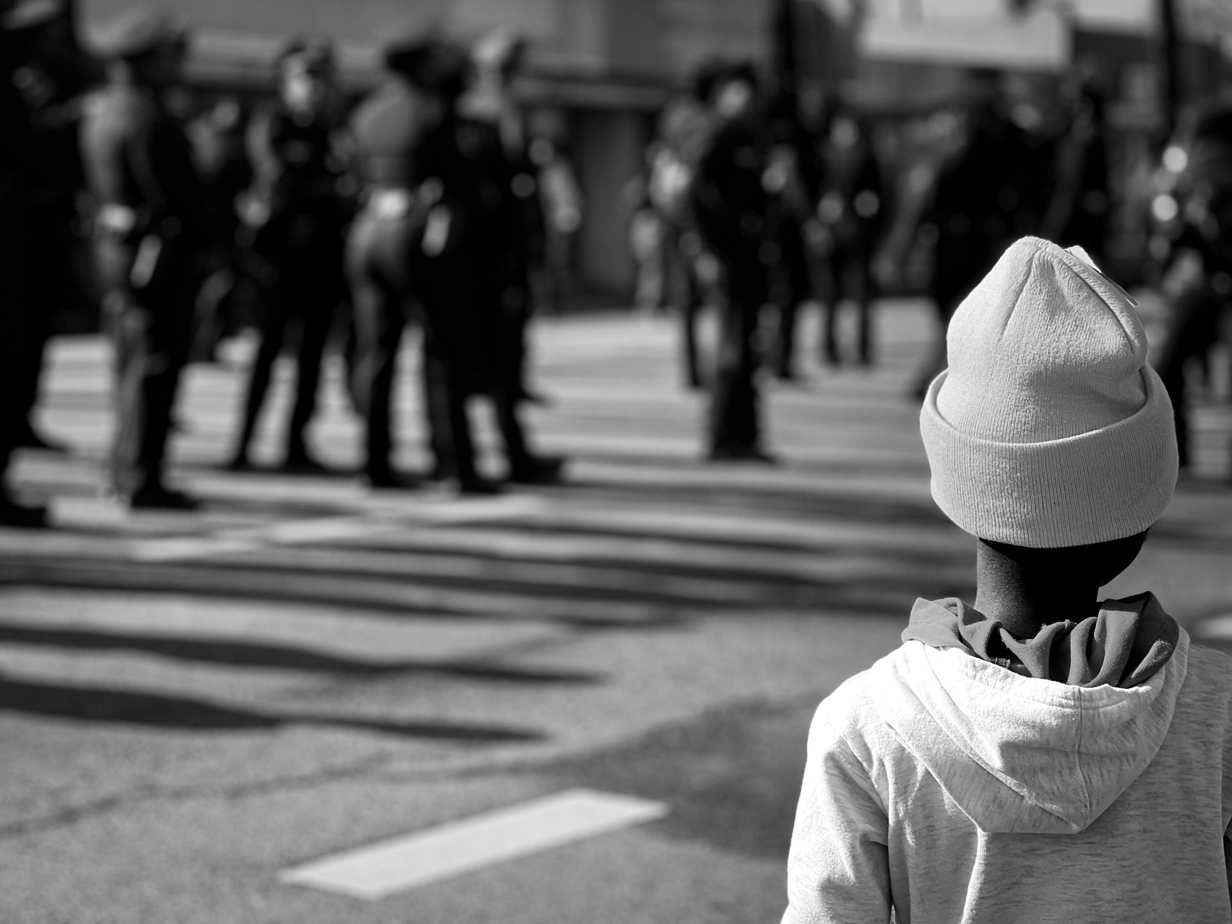 Girl with obscured face marching alongside police in the MLK Day Parade — Los Angeles, California