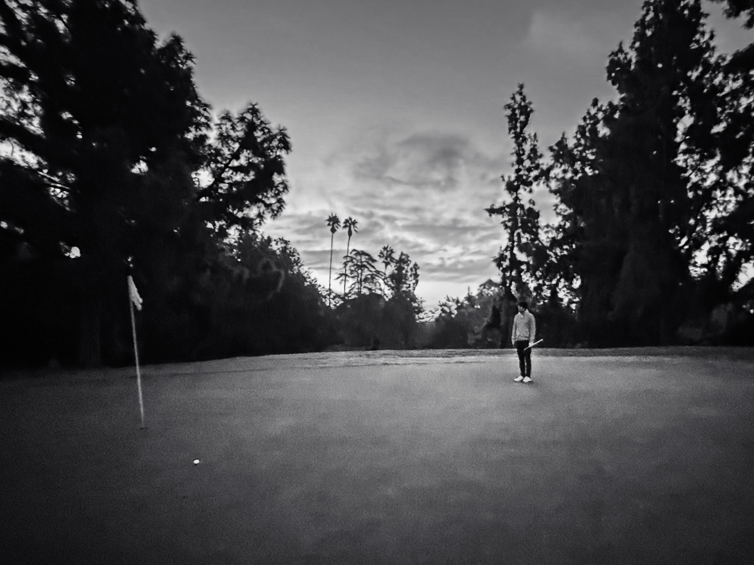 Golfer reading a putt in the early morning light — Eaton Canyon, California