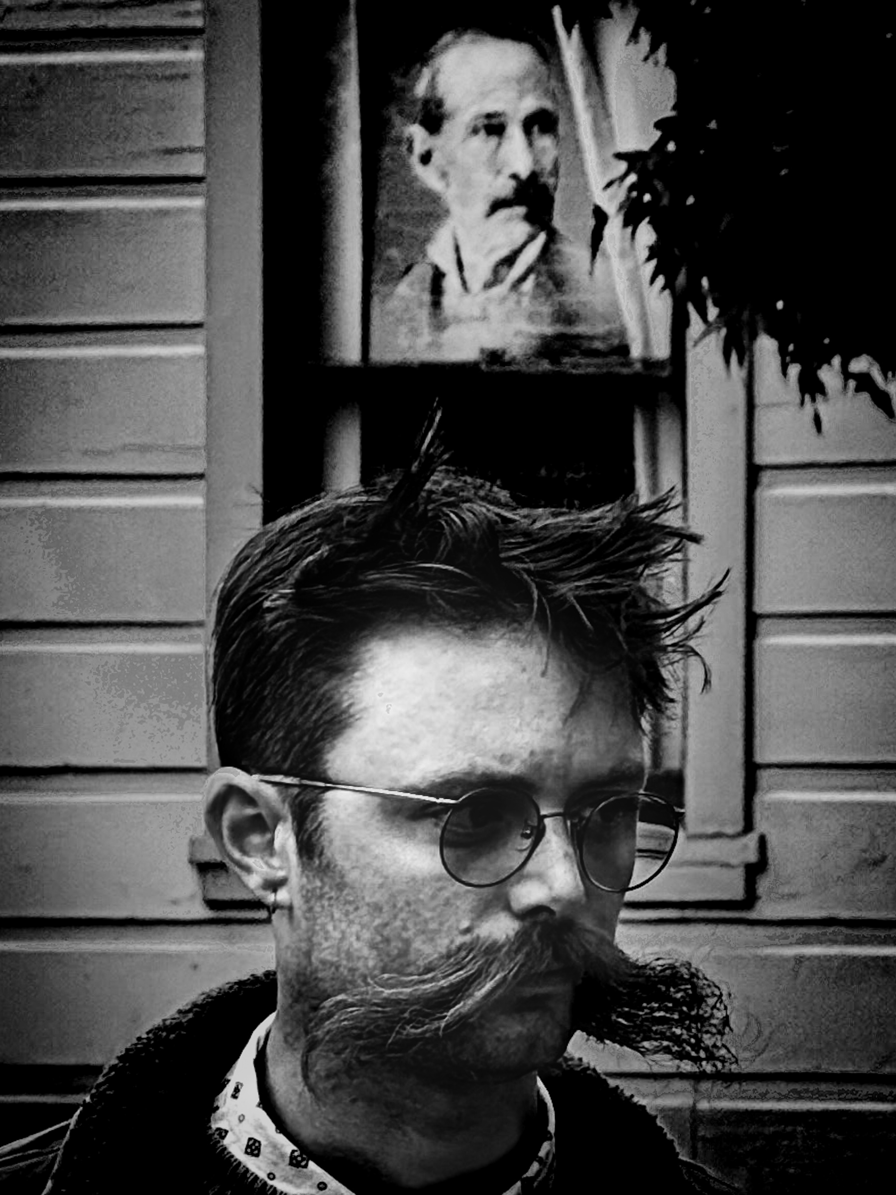 Man with prominent mustache in front of moustached portrait during the Art Crawl — South Pasadena, California