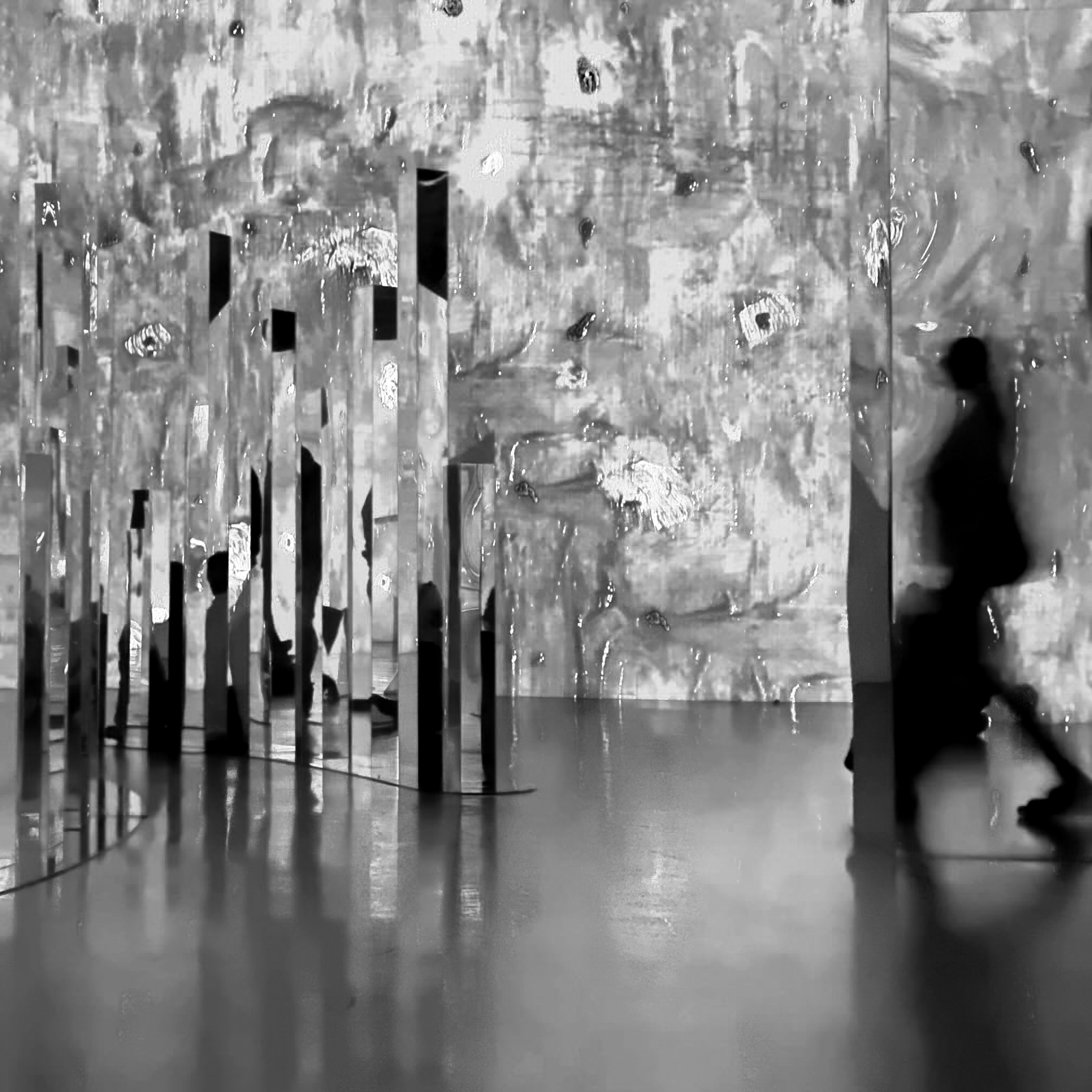 Person walking behind column