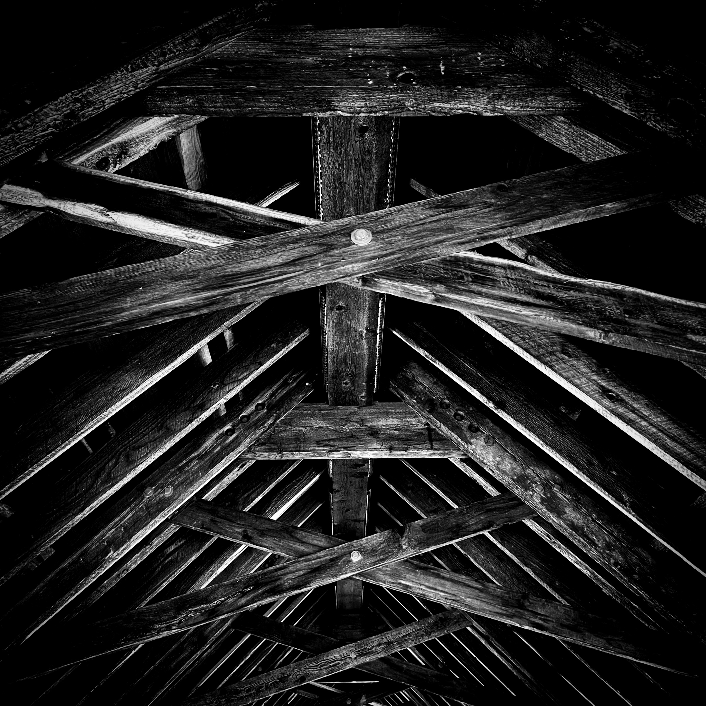 Interior barn rafters in dramatic light — Whistler, British Columbia